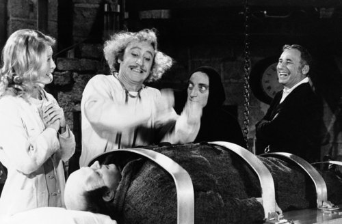 Director-writer Mel Brooks,right, enjoys the action during rehearsal of the film ?Young Frankenstein? featuring, left to right, Teri Garr, Gene Wilder, Marty Feldman and, on the table as the monster, Peter Boyle, May 16, 1974 in Los Angeles. Wilder plays the grandson of the old monster-making Frankenstein, repeating some of his grandfather?s experiments in some what raucous fashion. (AP Photo) No Sales